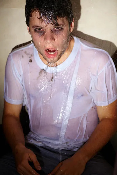 Portrait de jeune homme dramatique avec de l'eau, assis dans la douche ca — Photo