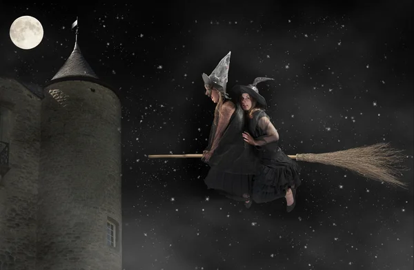 Two scared witches flying on a broom. Black background — Stock Photo, Image