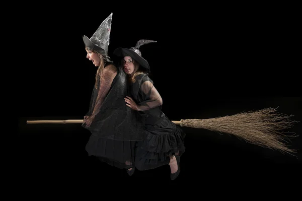 Two scared witches flying on a broom — Stock Photo, Image