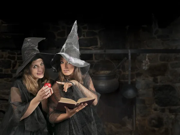 Two halloween witches pronouncing a magic formula — Stock Photo, Image