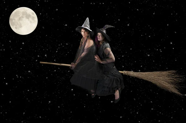 Two halloween witches flying on a broom — Stock Photo, Image