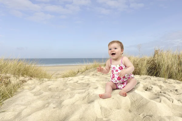 Baby girl in swimwear in the dunes — Stock Photo, Image