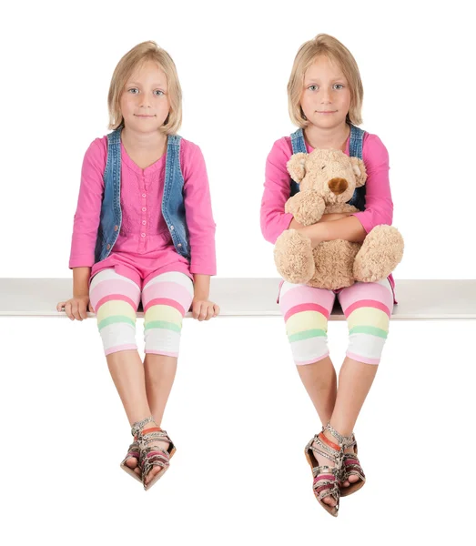 Twin girl with teddy bear on white — Stock Photo, Image