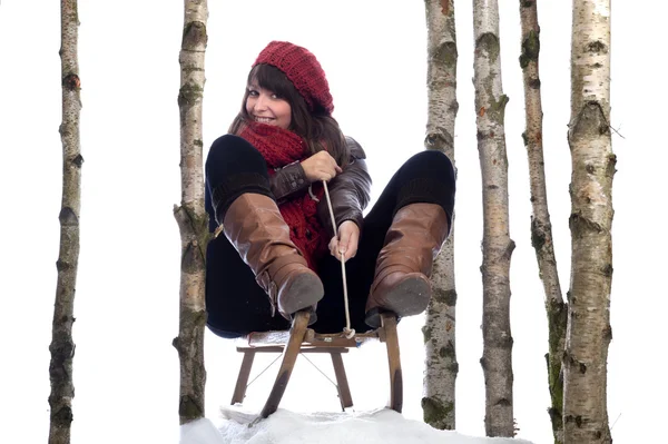 Winterfun: young woman on sledge — Stock Photo, Image