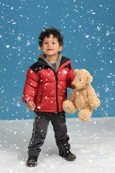 Little boy with teddy bear in the snow — Stock Photo, Image