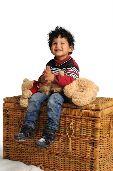 Little boy seated on a big basket — Stock Photo, Image