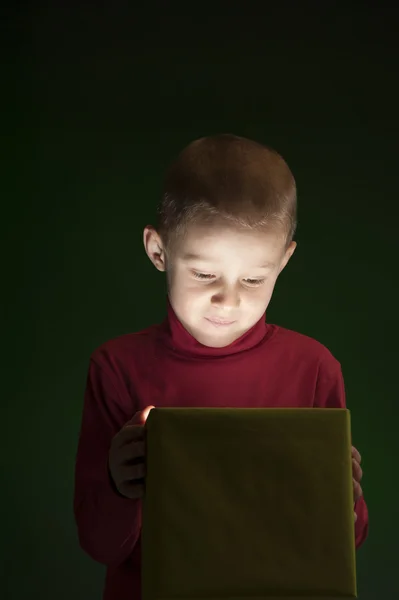 Boy with present, light coming out of the box — Stock Photo, Image