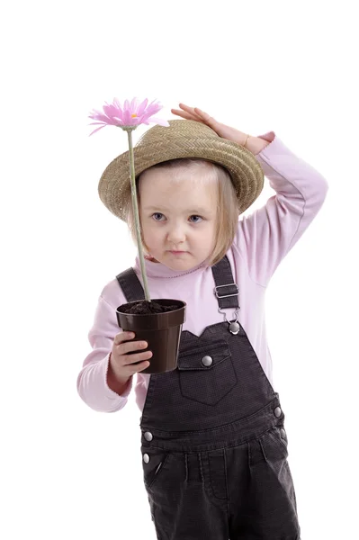 Little girl wit straw hat and pink flower in pot — Stock Photo, Image