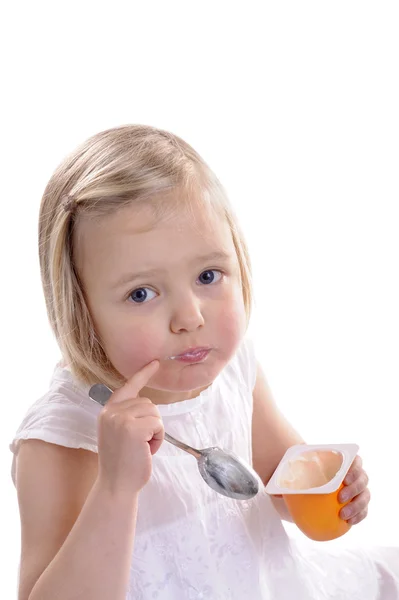 Little girl eating youghurt — Stock Photo, Image