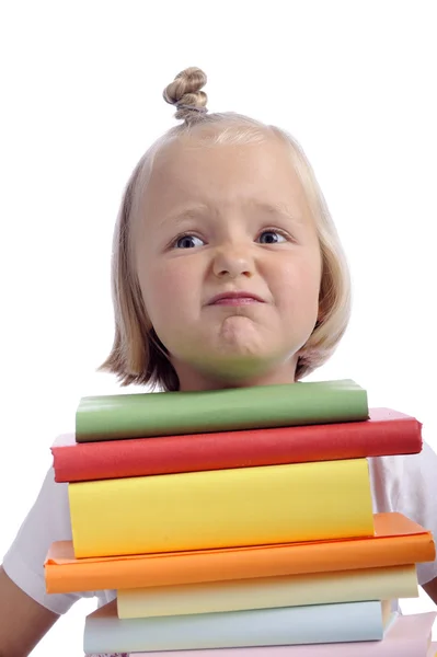 Unhappy little girl with stack of books — Stock Photo, Image