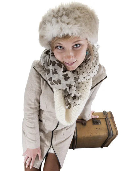 Young woman in winterclothes with suitcases, isolated on white — Stock Photo, Image