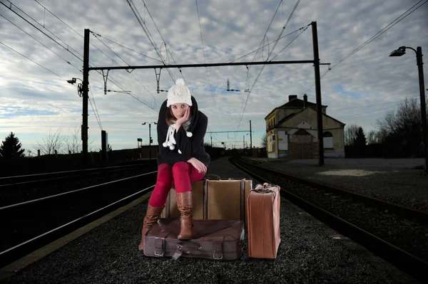 Bored young woman waiting for her train — Stock Photo, Image