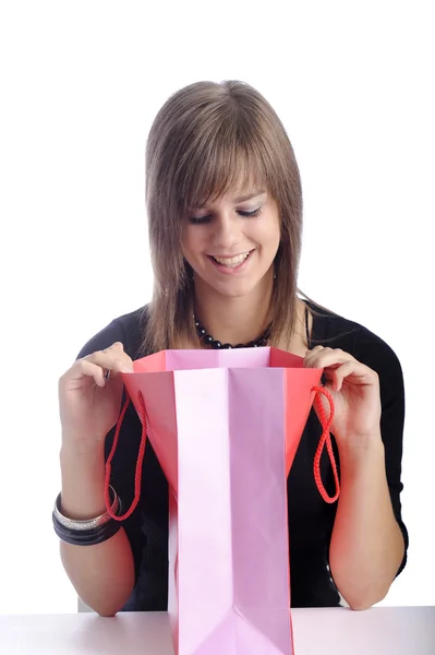Happy teenager looking in her shopping bag — Stock Photo, Image