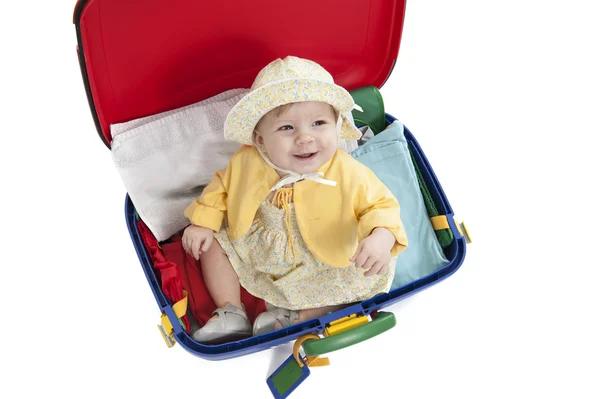 Baby girl seated in a suitcase on white — Stock Photo, Image