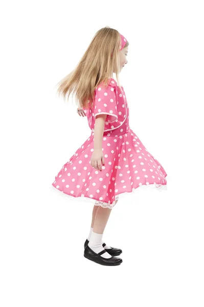 Klein meisje dansen in roze jurk — Stockfoto