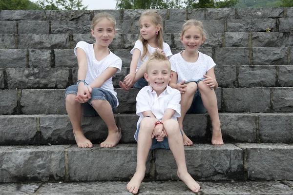 Group of children seated on stairs — Stock Photo, Image