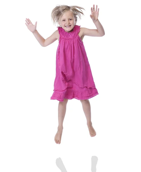 Jumping girl in pink dress, isolated on white — Stock Photo, Image