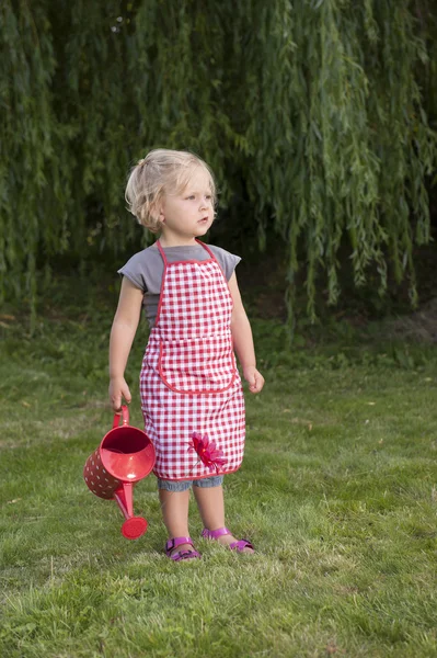 Little girl with watering can in the garden — Stock Photo, Image