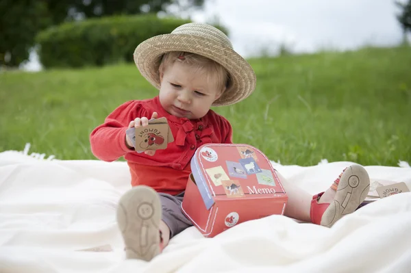 Toddler palying outdoors with memo cards — Stock Photo, Image