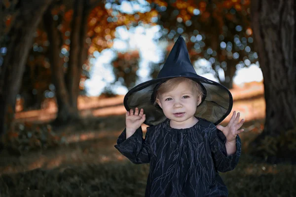 Little halloween witch outdoors — Stok fotoğraf