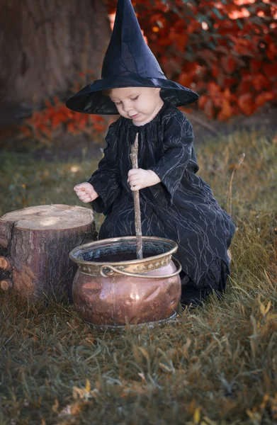 Little halloween witch outdoors in the woods — Stock Photo, Image