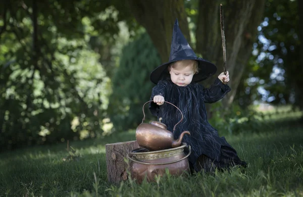 Little halloween witch outdoors in the woods — Stock Photo, Image