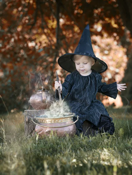 Petite sorcière d'Halloween avec couldron à l'extérieur — Photo