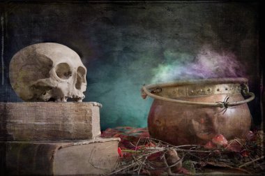 old skull on old book and copper cauldron clipart