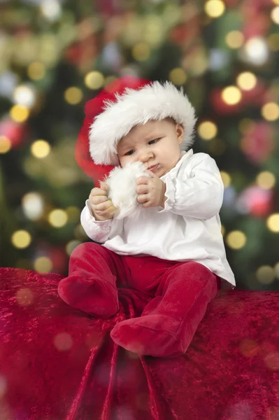 Little santa baby with christmas hat Stock Picture