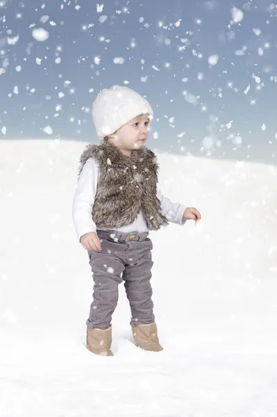 Kleines Kleinkind steht im Schnee — Stockfoto