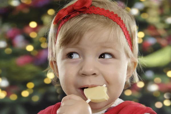 Cute little toddler eating a chocolate lolly — Stock Photo, Image