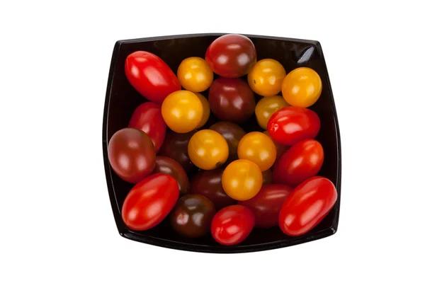 Cherry tomatoes in black plate isolated on white background — Stock Photo, Image