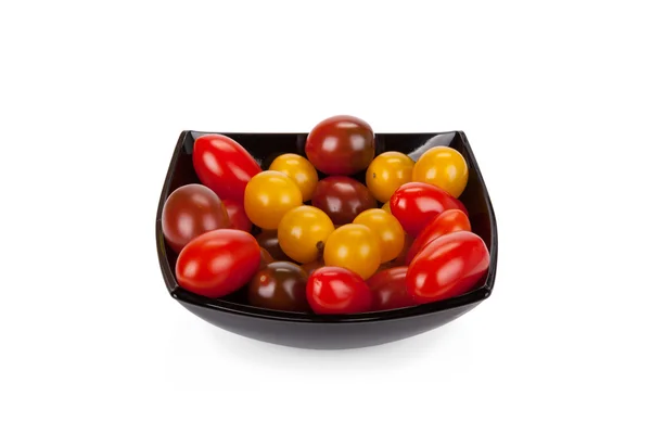 Cherry tomatoes in black plate isolated on white background — Stock Photo, Image