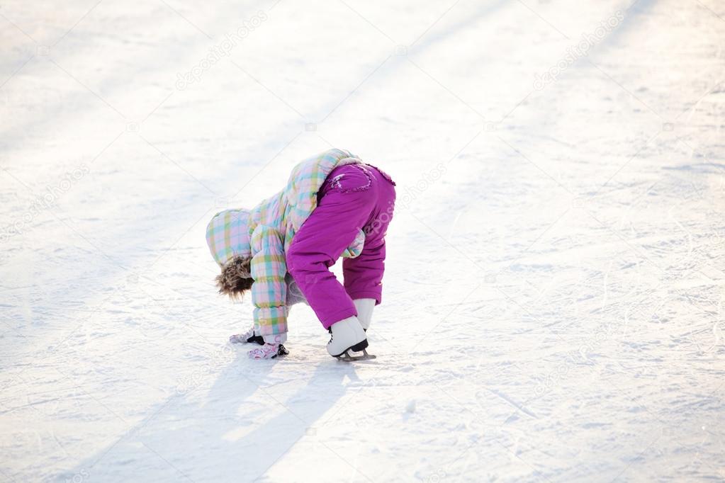 Little child learning how to ice skate