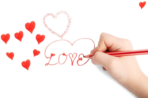 Mano del niño dibujando la tarjeta de San Valentín con corazones — Foto de Stock