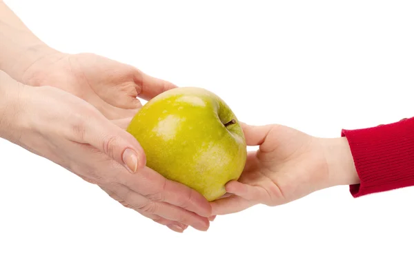 Mothers hands give apple to child's hands isolated on white back — Stock Photo, Image