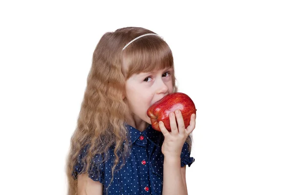 Adorable little girl biting red apple isolated on white backgrou Stock Photo