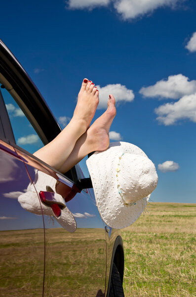 Woman legs out of car window