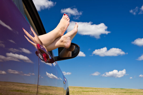 Woman legs out of car window