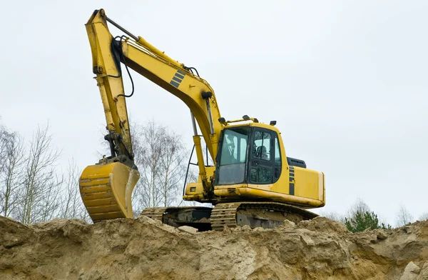 Yellow excavator on sandpit — Stock Photo, Image