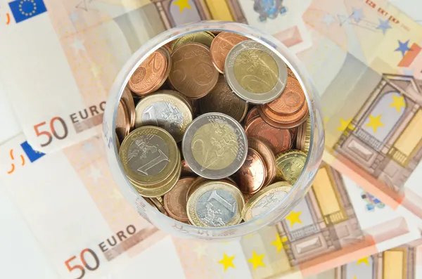 Euro coins in glass — Stock Photo, Image