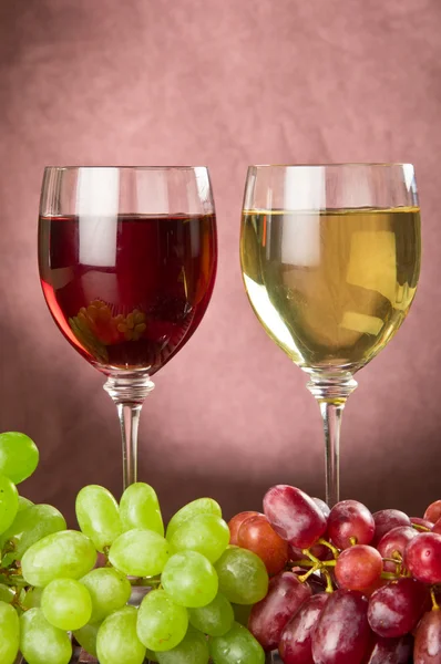 Volledige wijnglazen en druiven — Stockfoto