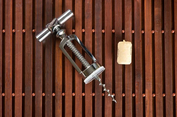 Corkscrew and wine cork — Stock Photo, Image
