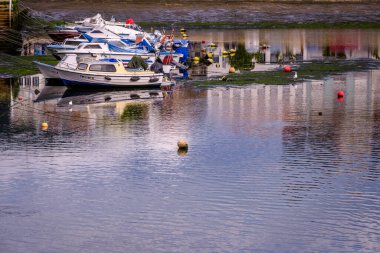 PONTEVEDRA, SPAIN - SEPTEMBER 25, 2021: Several pleasure and fishing boats anchored in the small dock of the city.