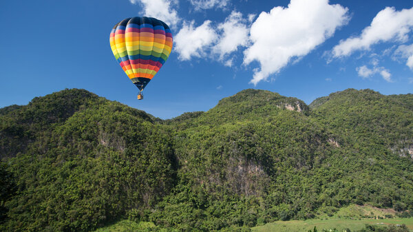 Tropical nature mountain with hot air balloon.