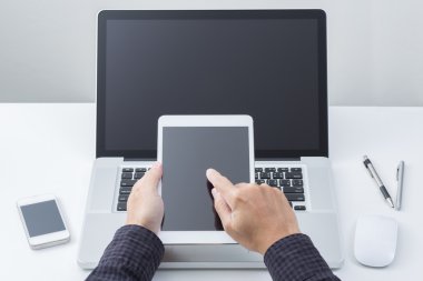 Man hand working on tablet with computer background. Technology. clipart