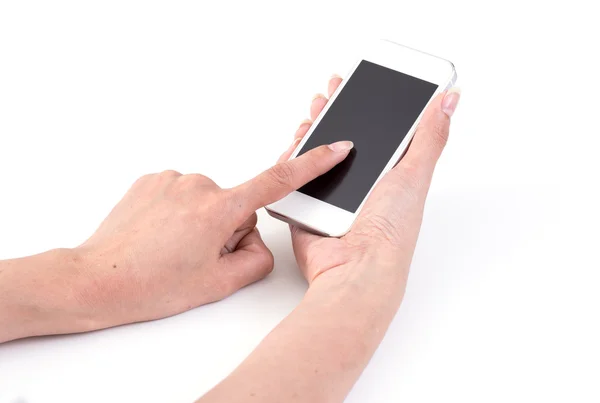 Ženy rukama dotýkat mobilní telefon na bílém pozadí — Stock fotografie