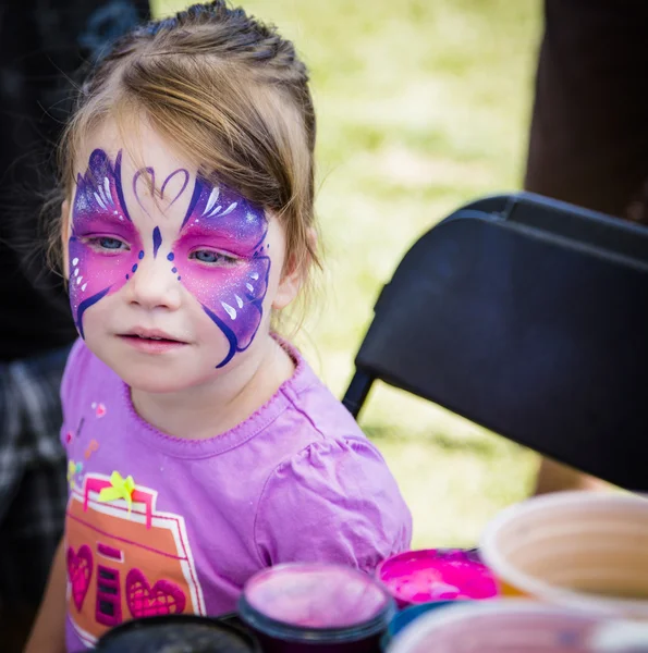 Jeune fille avec peinture papillon visage — Photo