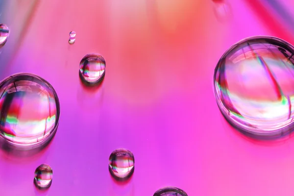 Macro of water drops on multicolor background — Stock Photo, Image