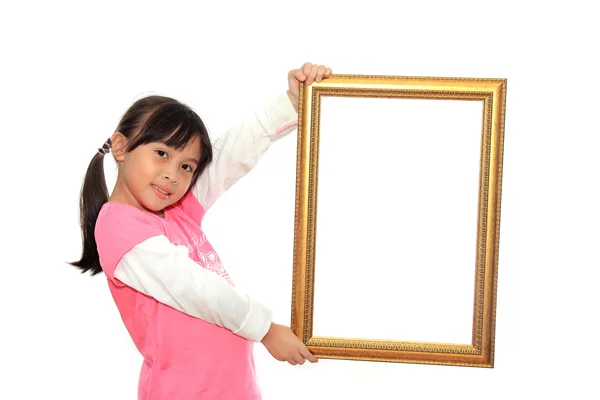 Gelukkig meisje houden een leeg afbeeldingsframe op witte backgro — Stockfoto